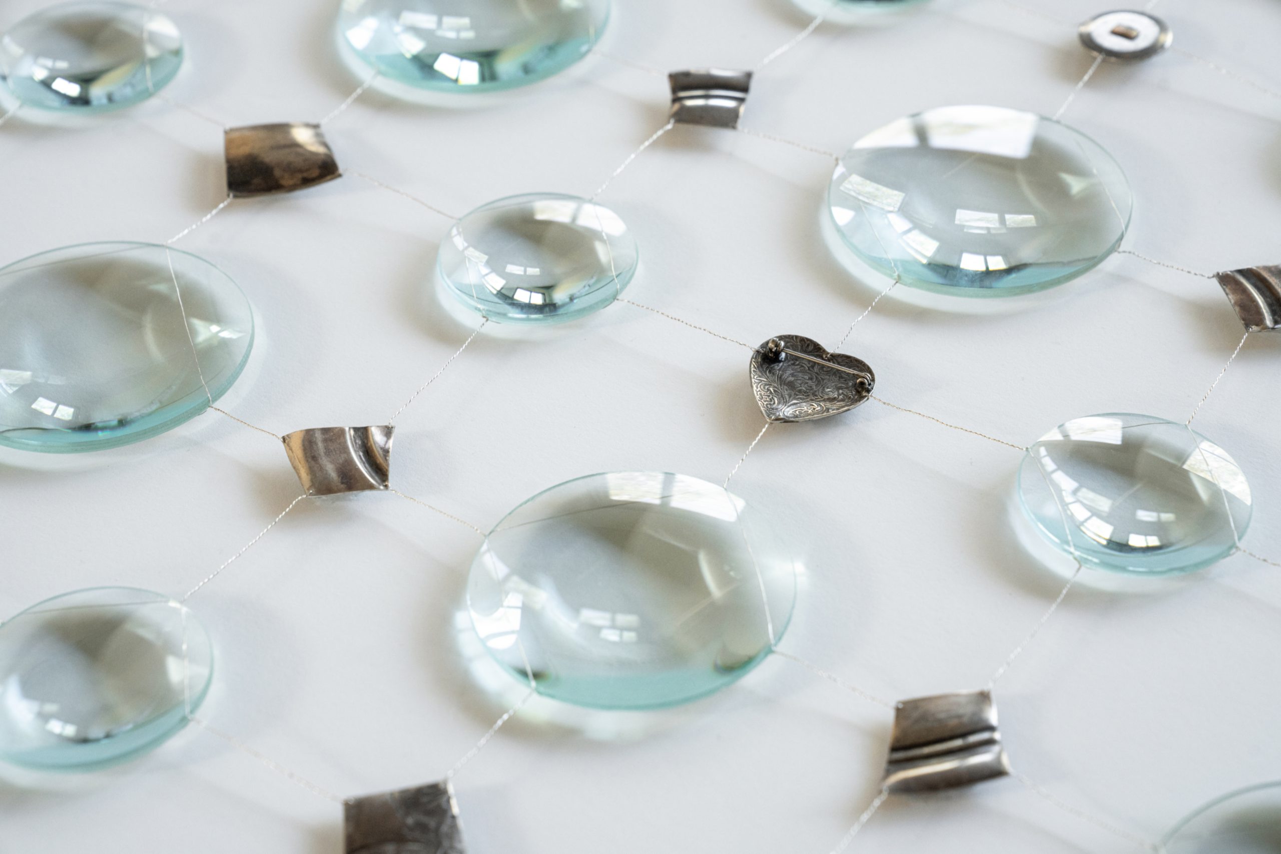 Claire BEAUSEIN 'Petrichor' [detail] 2024, Magnifying glasses, fragments of metal, silver wire and bronze rod on museum board, 85 x 152 cm